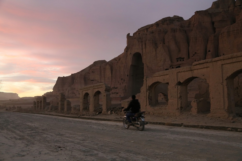 This photograph taken on November 19, 2019 shows a man riding his motorbike during sunset in front of the empty seat of one of the two Buddha statues destroyed by the Taliban in 2001 in Bamiyan Afghanistan. u00e2u20acu201d AFP pic 