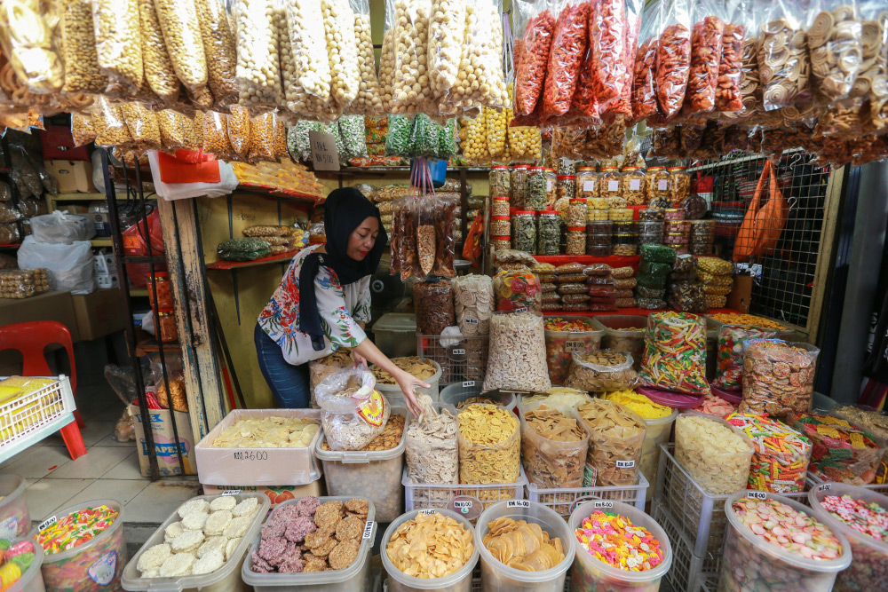 A stall at Pasar Chow Kit offering a medley of colourful biscuits and snacks. u00e2u20acu201d Picture by Ahmad Zamzahuri