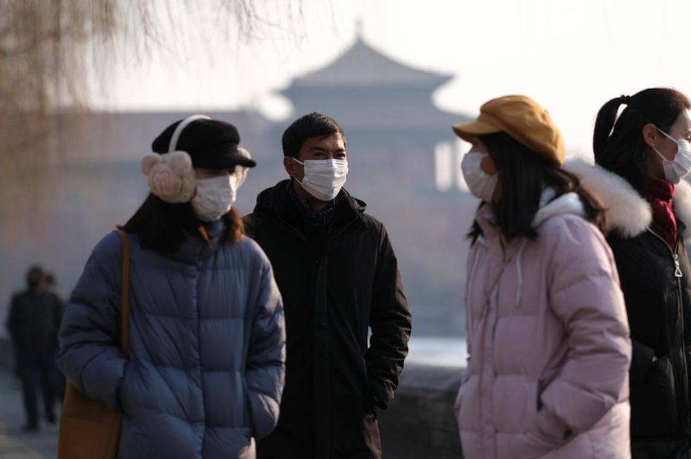 People wearing protective masks walk outside Forbidden City which is closed to visitors, according to a notice in its main entrance for the safety concern following the outbreak of a new coronavirus, in Beijing, China January 25, 2020. u00e2u20acu201d Reuters pic