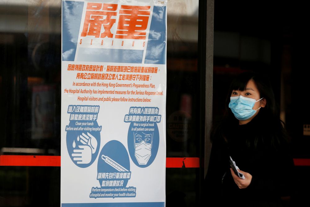 A woman wears a mask as she walks past a health warning poster at hospital, in Hong Kong January 21, 2020. u00e2u20acu201d Reuters pic