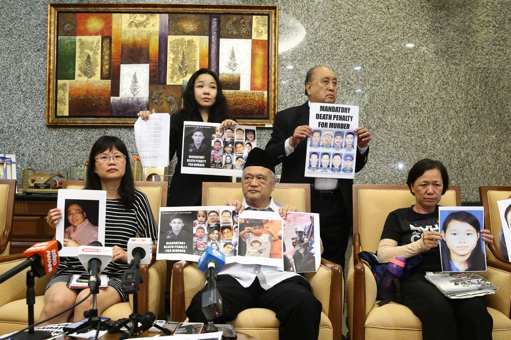 Representatives and family members of murder victims who refuse to accept the abolishment of the death penalty pose for a group photo in Putrajaya January 14, 2020. — Picture by Yusof Mat Isa