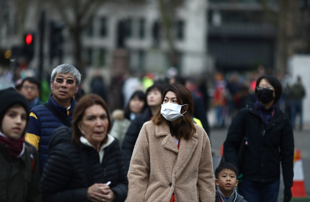 People wearing face masks are pictured in London January 31, 2020. u00e2u20acu201d Reuters pic
