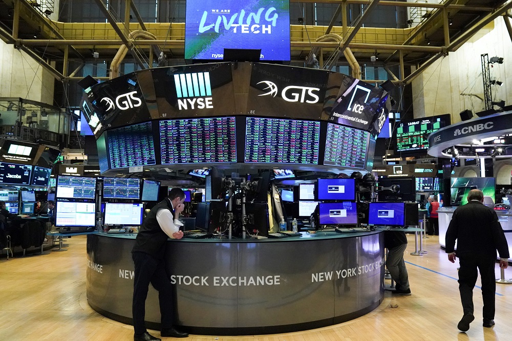Traders work at the New York Stock Exchange.On Wall Street, travel stocks weighed on sentiment, with airline and cruise operators falling sharply. — Reuters pic