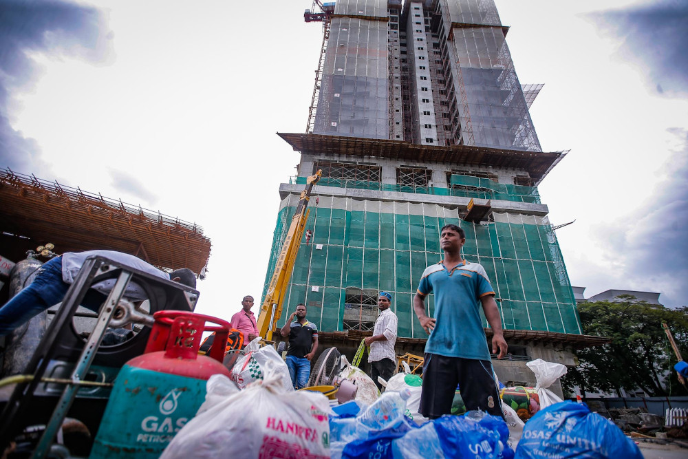 Construction workers moving out from temporary quarters inside the building site in Taman Desa, Kuala Lumpur February 15, 2020. — Picture by Hari Anggara