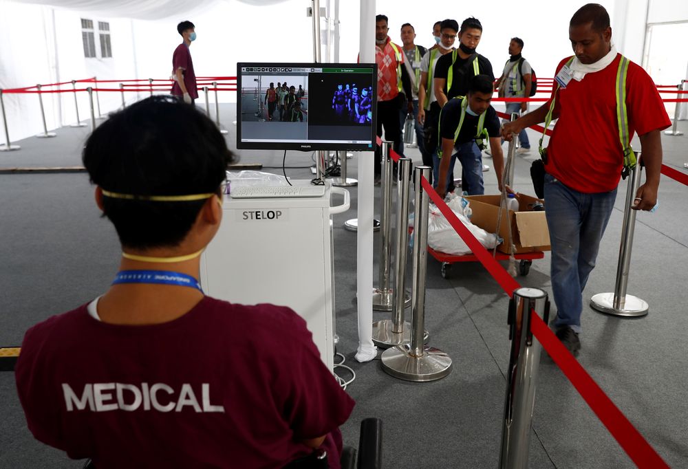 Contractors and workers pass a thermal scanner as part of the coronavirus outbreak precautions during a media preview of the Singapore Airshow in Singapore February 9, 2020. u00e2u20acu201d Reuters pic