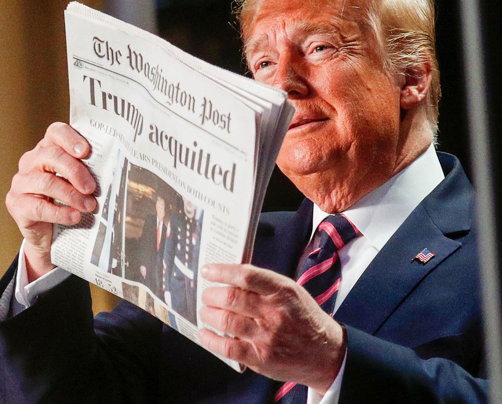 US President Donald Trump holds up a copy of the Washington Postu00e2u20acu2122s front page showing news of his acquittal in his Senate impeachment trial, as he arrives to address the National Prayer Breakfast in Washington, February 6, 2020. u00e2u20acu201d Reuters pic
