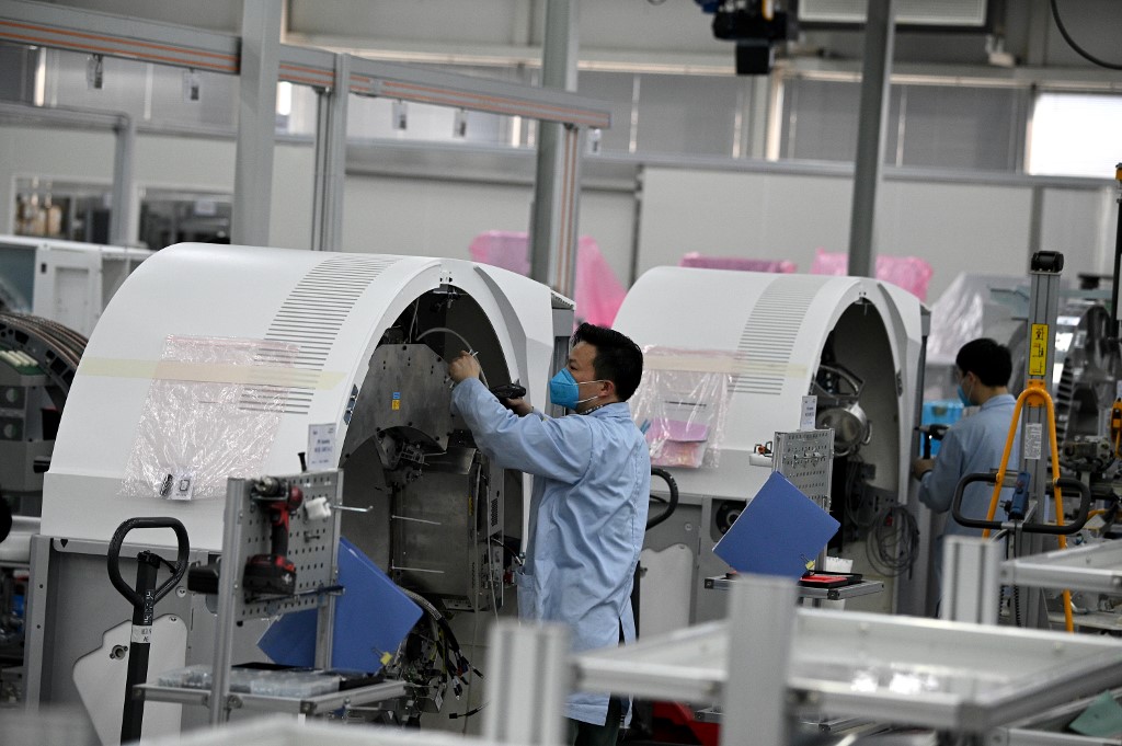 Employees wearing protective face masks work at the Siemens factory where medical equipment is assembled in Shanghai on February 24, 2020. u00e2u20acu201d AFP pic