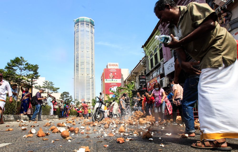 Devotees smash coconuts along Jalan Dato Keramat, George Town, as the silver chariot passes by, February 7, 2020. u00e2u20acu2022 Picture by Sayuti Zainudin 