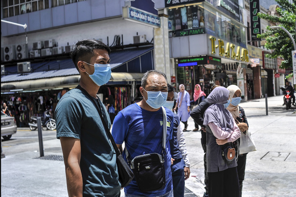 People are seen wearing face masks to protect themselves against the new coronavirus in Kuala Lumpur March 15, 2020. ― Picture by Shafwan Zaidon