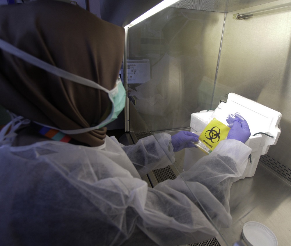 A lab technician processes a test sample during a screening process for the Covid-19 virus at the Institute for Medical Research in Kuala Lumpur February 26, 2020. — Bernama pic