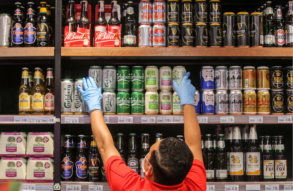 A Jaya Grocer staff arranging cans of beer in Ipoh. Some supermarkets and mini markets saw a shortage in beer supply after a few beer companies shut down their operations following the MCO. u00e2u20acu201d Picture by Farhan Najib