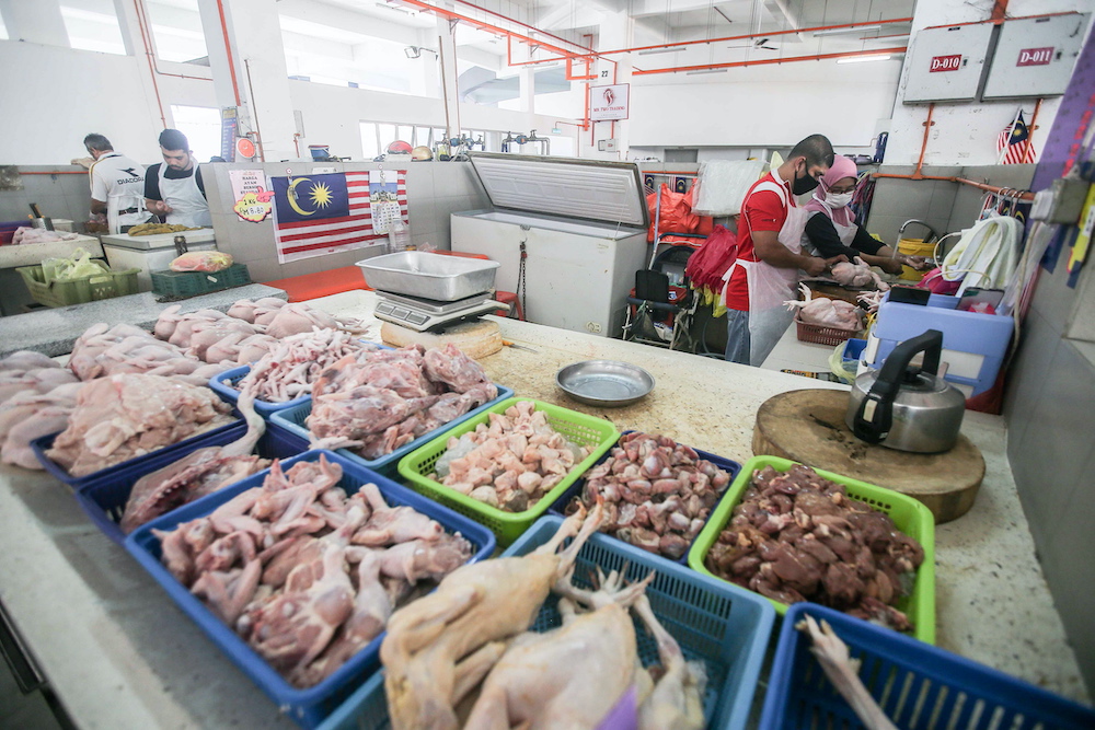 Chicken traders are pictured at the Ipoh Central Market March 25, 2020. —  Picture by Farhan Najib