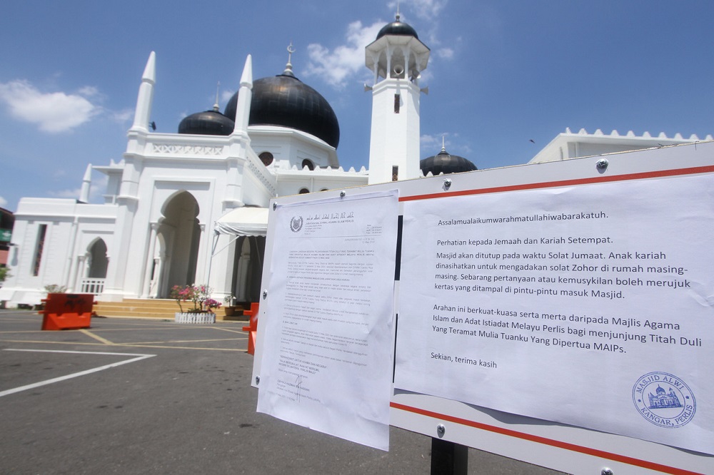 A notice is seen outside the Alwi Mosque informing the public that Friday prayers are cancelled due to the Covid-19 outbreak, in Kangar March 13, 2020. u00e2u20acu201d Bernama pic