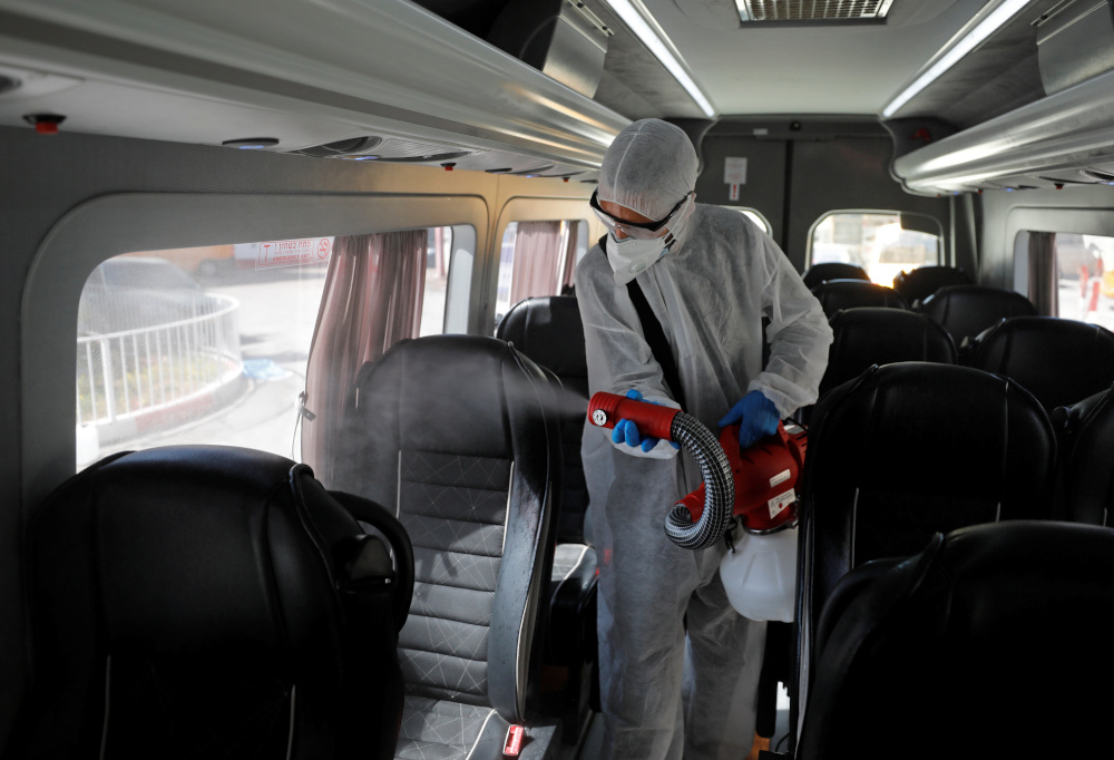 A Palestinian worker in a protective suit disinfects a bus as a preventive measure against the coronavirus in Beit Jala town in the Israeli-occupied West Bank March 5, 2020. u00e2u20acu201d Reuters pic 