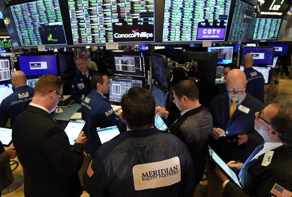 Traders work on the floor of the New York Stock Exchange during the opening bell, March 10, 2020 in New York. — AFP pic