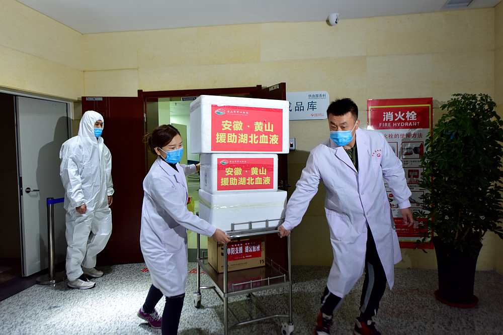 Staff members wearing face masks move blood supplies to be sent to Wuhan at a blood centre in Hefei, Anhui province, China March 1, 2020. u00e2u20acu201d China Daily pic via Reuters