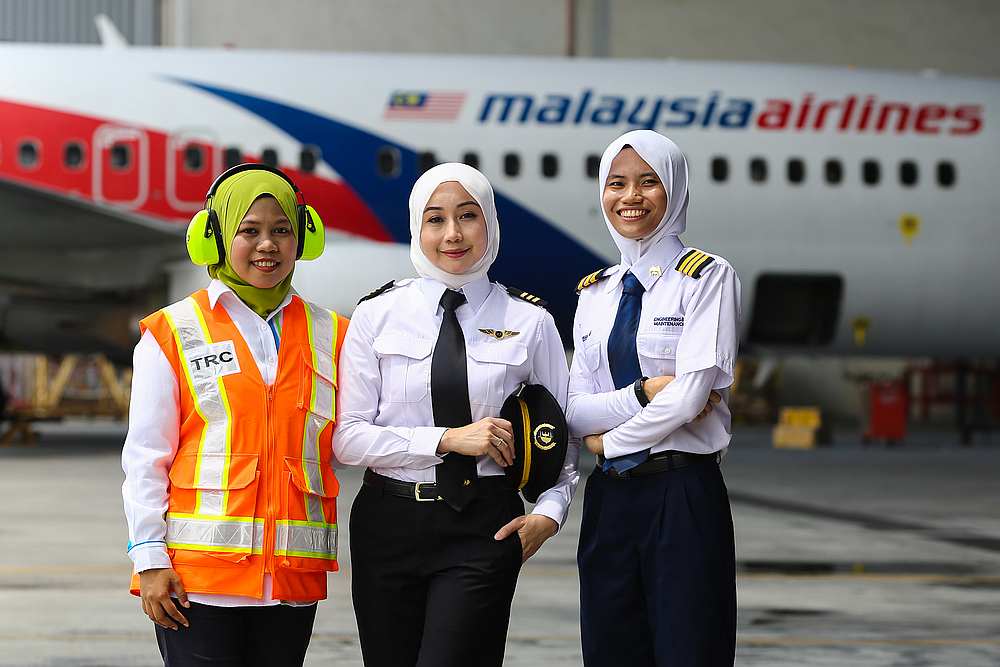 (From left) Aircraft turnaround coordinator Nur Syamimi Zaidi, first officer Munirah Muhsin, and licensed aircraft engineer Izzah Fuzain Yusof are carving out a career in the world of aviation. u00e2u20acu201d Picture by Yusof Mat Isa