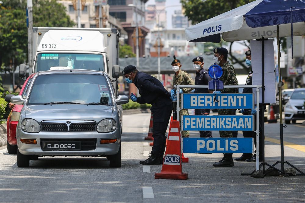 Police and Armed Forces personnel conduct checks during a roadblock in Kuala Lumpur March 31, 2020. u00e2u20acu201d Picture by Yusof Mat Isa