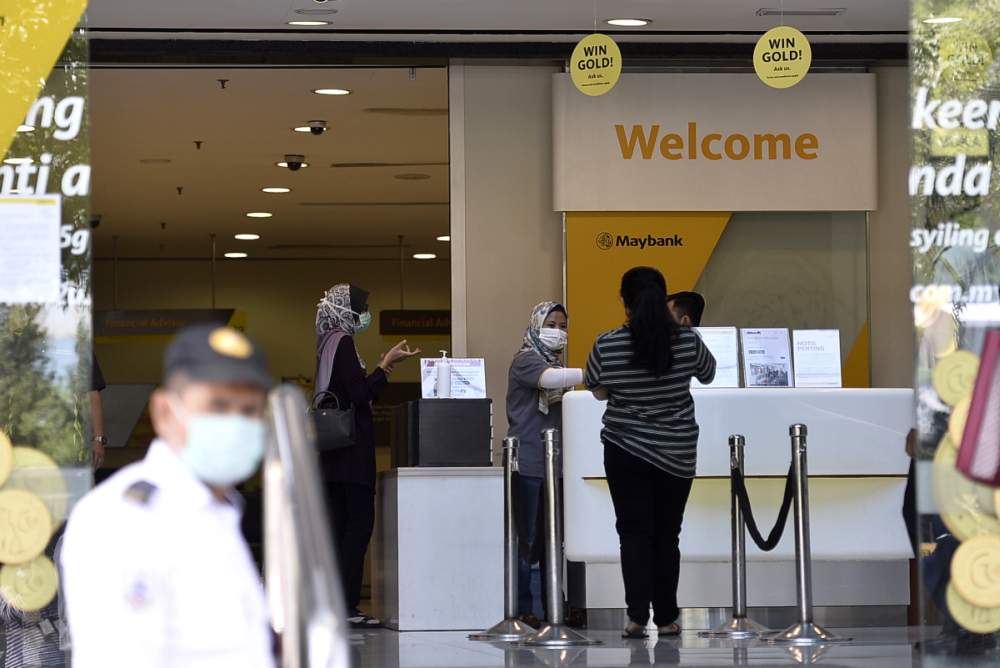People are seen at a Maybank branch in Shah Alam March 26, 2020. u00e2u20acu2022 Picture by Miera Zulyana