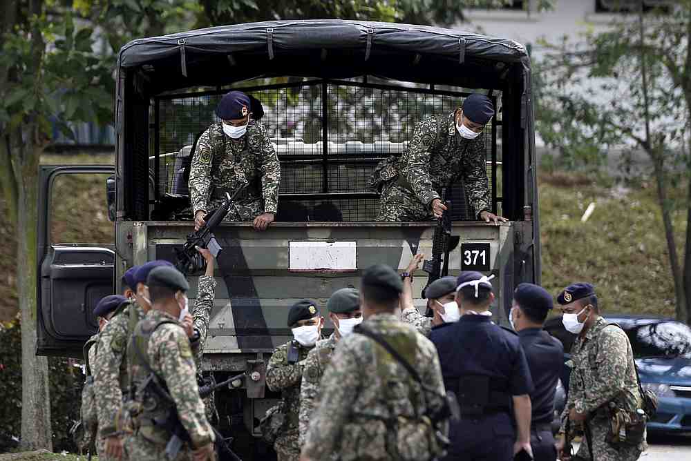 The Regimen 502 Askar Wataniah from Kem Sungai Buloh arriving at Shah Alam police station to help enforce the movement control order March 22,2020. u00e2u20acu201d Picture by Miera Zulyana