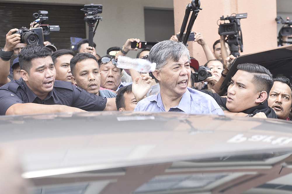 PKR’s Tian Chua heckled and jostled by PKR supporters in front of party headquarters in Petaling Jaya March 1, 2020. — Picture by Miera Zulyana