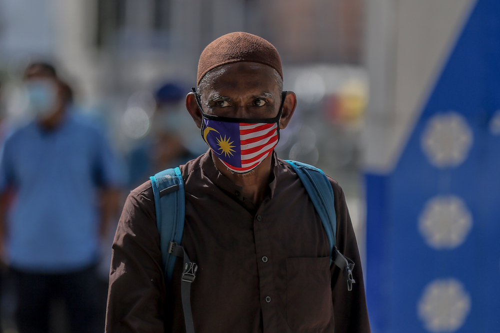 A man wearing a protective mask is seen at Chow Kit market during the movement control order (MCO) in Kuala Lumpur April 5, 2020. u00e2u20acu201d Picture by Firdaus Latif