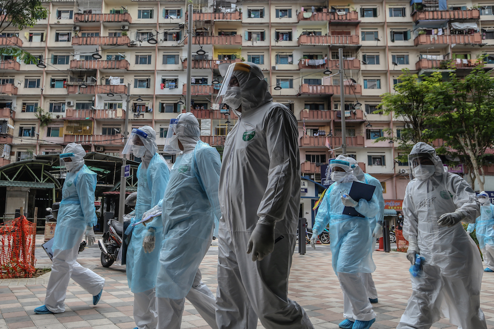 Health workers in protective suits are seen at Selangor Mansion and Malayan Mansion in Jalan Masjid India April 7, 2020. u00e2u20acu201d Picture by Firdaus Latif