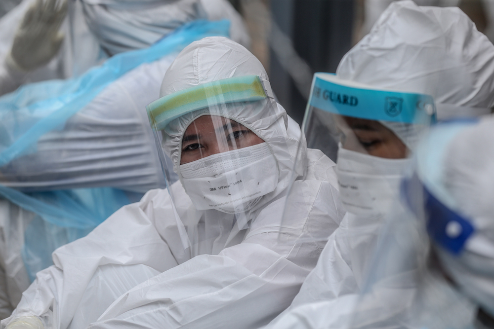 Health workers in protective suits are seen at Selangor Mansion and Malayan Mansion in Jalan Masjid India April 7, 2020. — Picture by Firdaus Latif