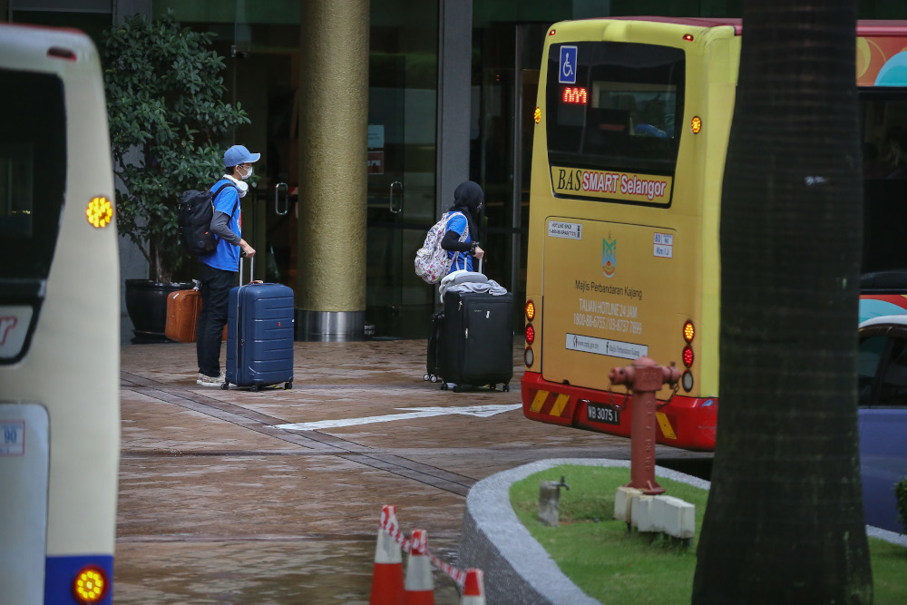 Malaysians returning from overseas queue to take a bus to a quarantine centre in Kuala Lumpur April 8, 2020. u00e2u20acu201dPicture by Yusof Mat Isa
