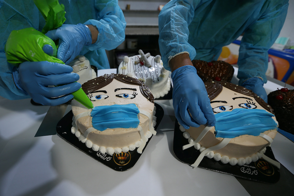 Palestinians put final touches on cakes shaped like a character wearing a mask amid concerns about the spread of coronavirus disease (Covid-19), in a bakery in Khan Younis in the southern Gaza Strip March 30, 2020. u00e2u20acu201d Reuters pic