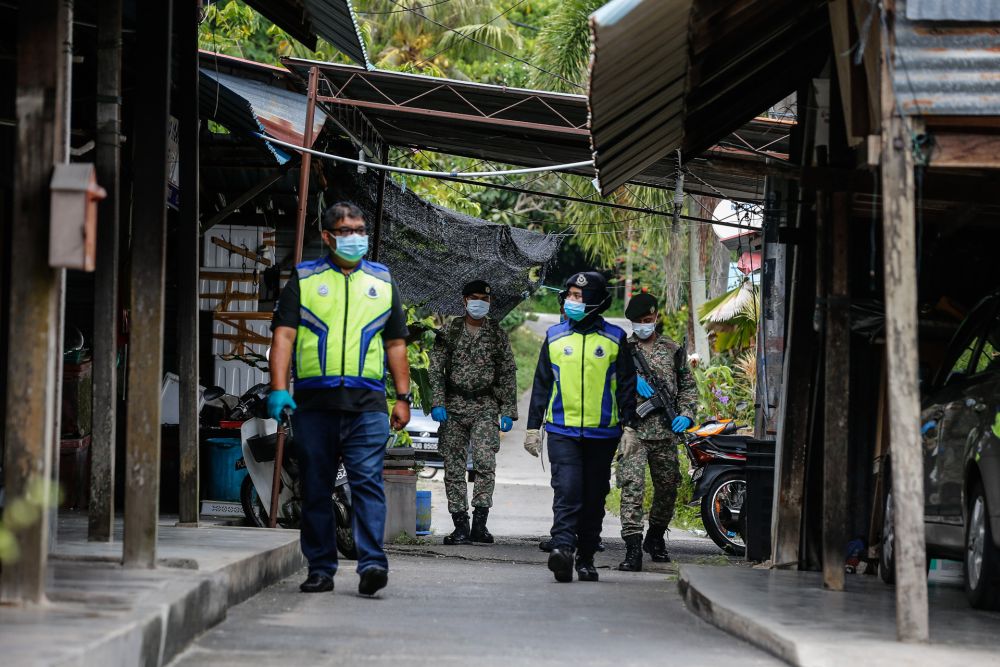 Police and Armed Forces personnel patrol the vicinity of Kampung Pulau Betong in Balik Pulau April 8, 2020. u00e2u20acu201d Picture by Sayuti Zainudin