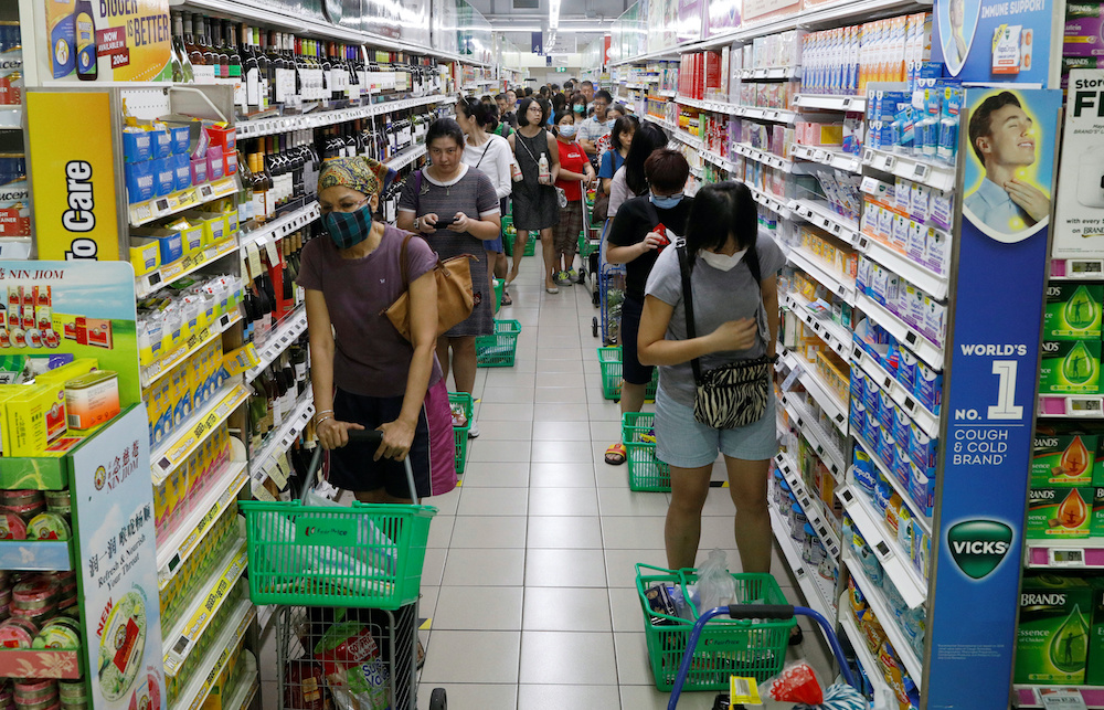 People stand behind markers as they practice social distancing while queueing up to buy food at a supermarket, during the outbreak of coronavirus disease (Covid-19), in Singapore April 3, 2020. u00e2u20acu201d Reuters picnn