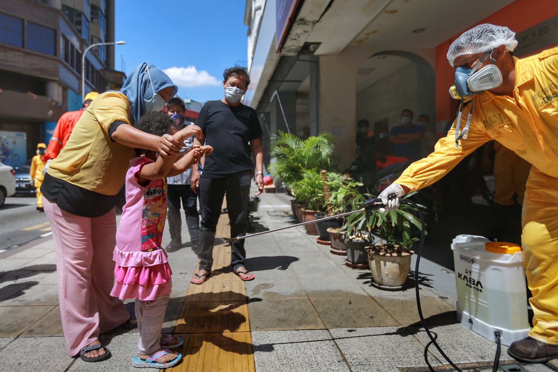 A DBKL personnel sprays disinfectant at a public area in Kuala Lumpur April 4, 2020. ― Picture by Ahmad Zamzahuri
