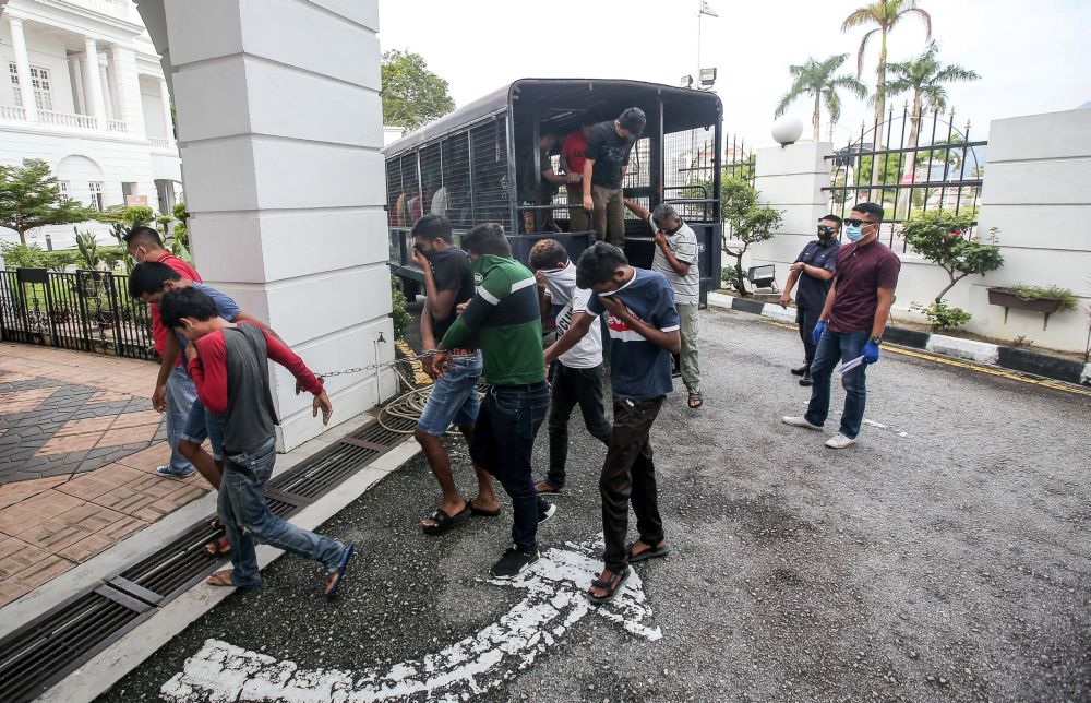 Police round up detainees who flouted the movement control order at the Ipoh Magistrateu00e2u20acu2122s Court April 2, 2020. u00e2u20acu201d Picture by Farhan Najib
