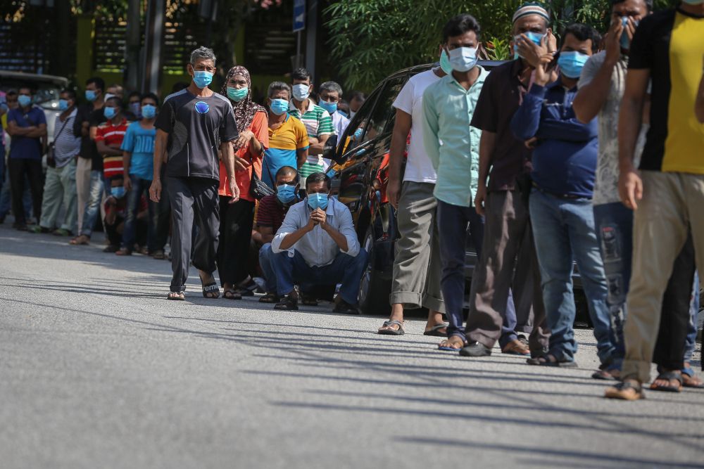 Foreign workers queue up to be tested for Covid-19 at Kampung Baru, Kuala Lumpur April 16, 2020. u00e2u20acu201d Picture by Yusof Mat Isa
