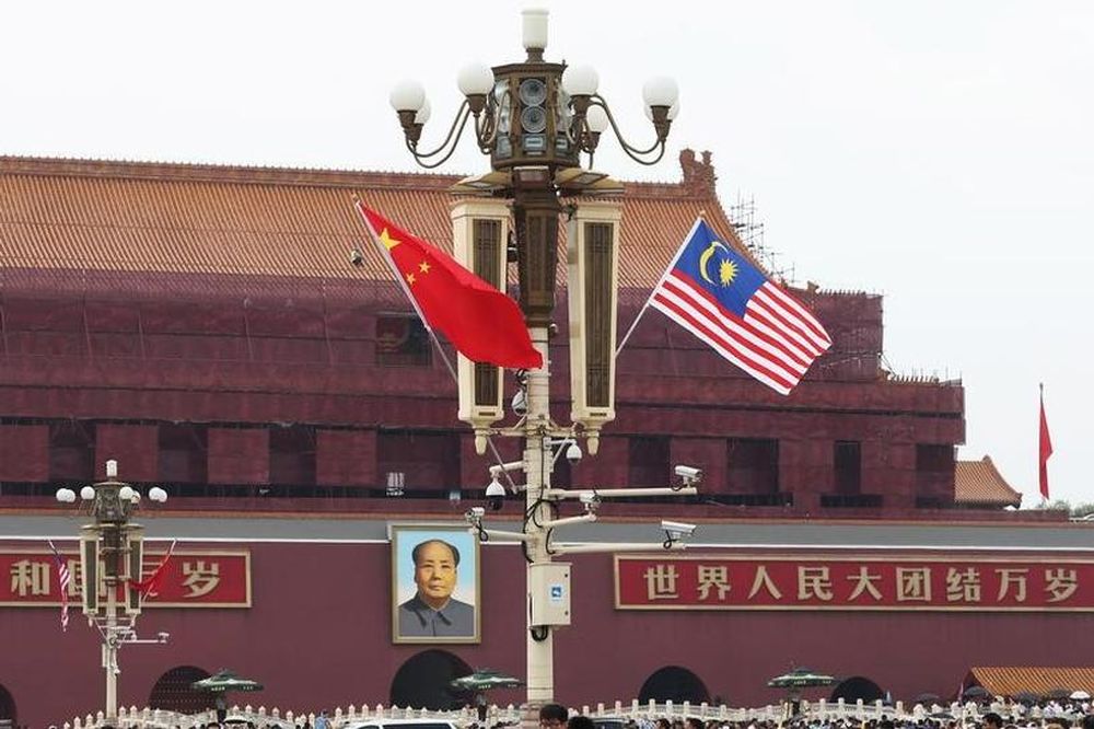 A Malaysian flag flutters next to a Chinese flag as Malaysian Prime Minister Tun Dr Mahathir Mohamad visits China, at Tiananmen Square in Beijing, China August 19, 2018. u00e2u20acu201d Reuters pic