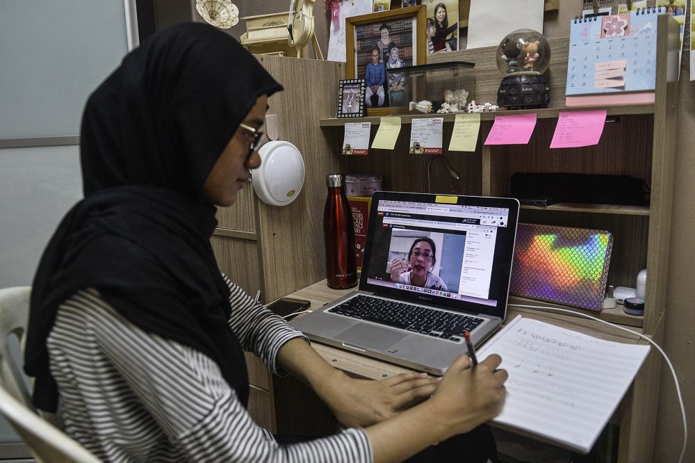 A student takes online lessons during phase three of the movement control order in Shah Alam. — Picture by Miera Zulyana