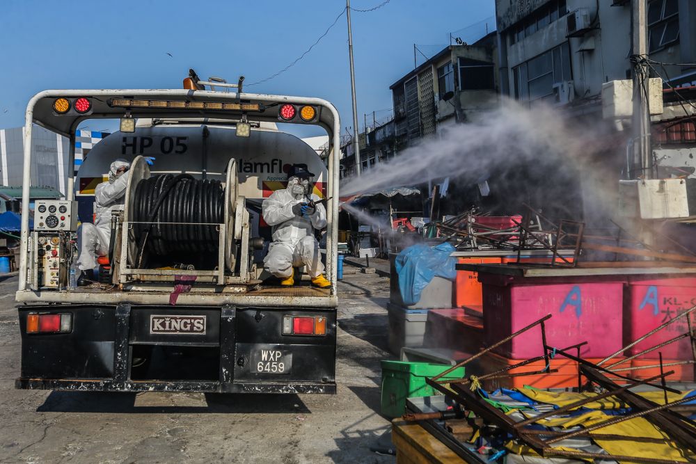 An Alam Flora personnel sprays disinfectant at Pasar Pudu to prevent the spread of the coronavirus in Kuala Lumpur April 1, 2020. u00e2u20acu201d Picture by Firdaus Latifnn