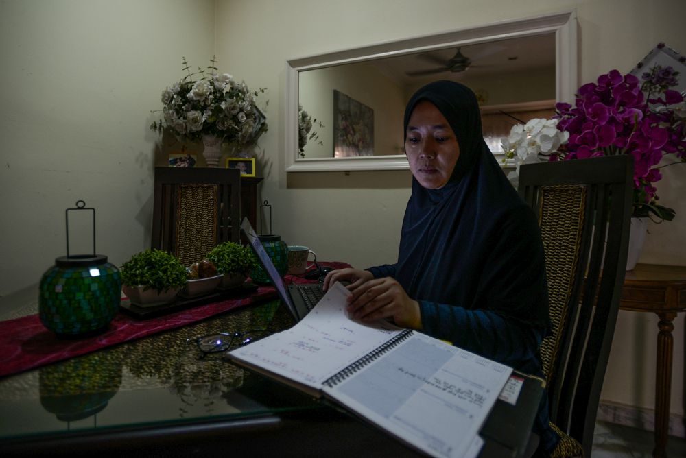 A woman is seen working from home during phase three of the movement control order in Shah Alam April 15, 2020. — Picture by Miera Zulyana