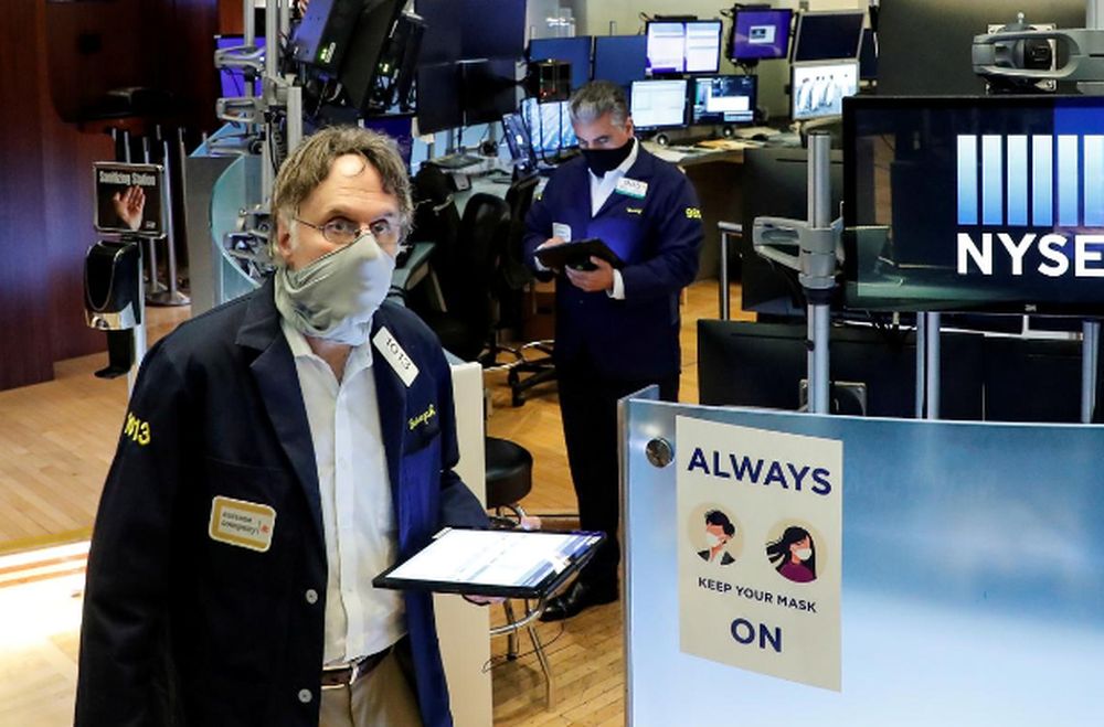 Traders wearing masks work, on the first day of in person trading since the closure during the outbreak of the coronavirus disease (Covid-19) on the floor at the New York Stock Exchange (NYSE) in New York, US, May 26, 2020. u00e2u20acu201d Reuters pic