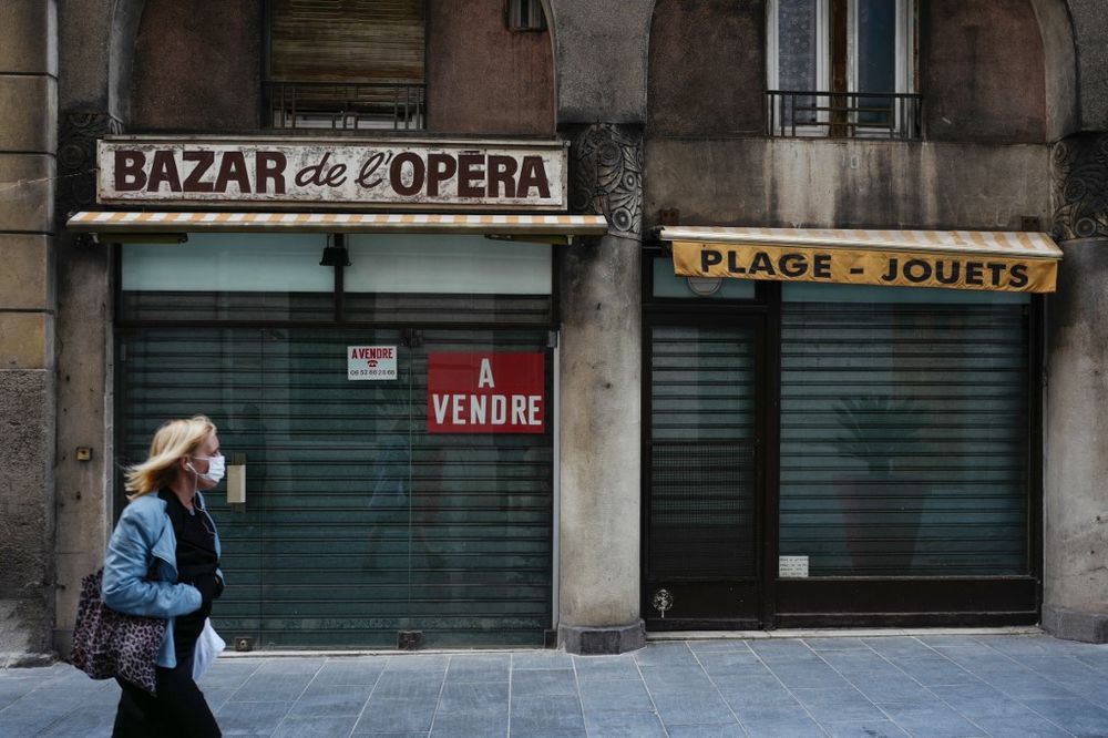 A woman walks past a closed shop with a u00e2u20acu02dcfor saleu00e2u20acu2122 sign in the French Riviera city of Nice, southern France, on the 43nd day of a lockdown in France aimed at curbing the spread of the Covid-19 pandemic, April 28, 2020. u00e2u20acu201d AFP pic