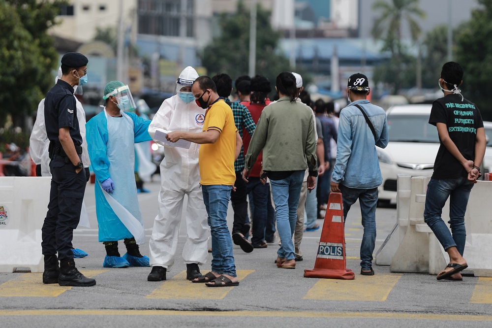 Health personnel assisting foreign workers during a Covid-19 screening in Kuala Lumpur May 8, 2020. u00e2u20acu2022 Picture by Ahmad Zamzahuri