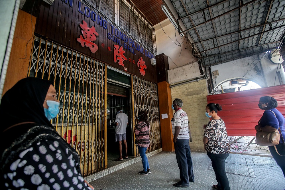 People queue up at a pawn shop in Ipoh May 5, 2020. u00e2u20acu2022 Picture by Farhan Najib