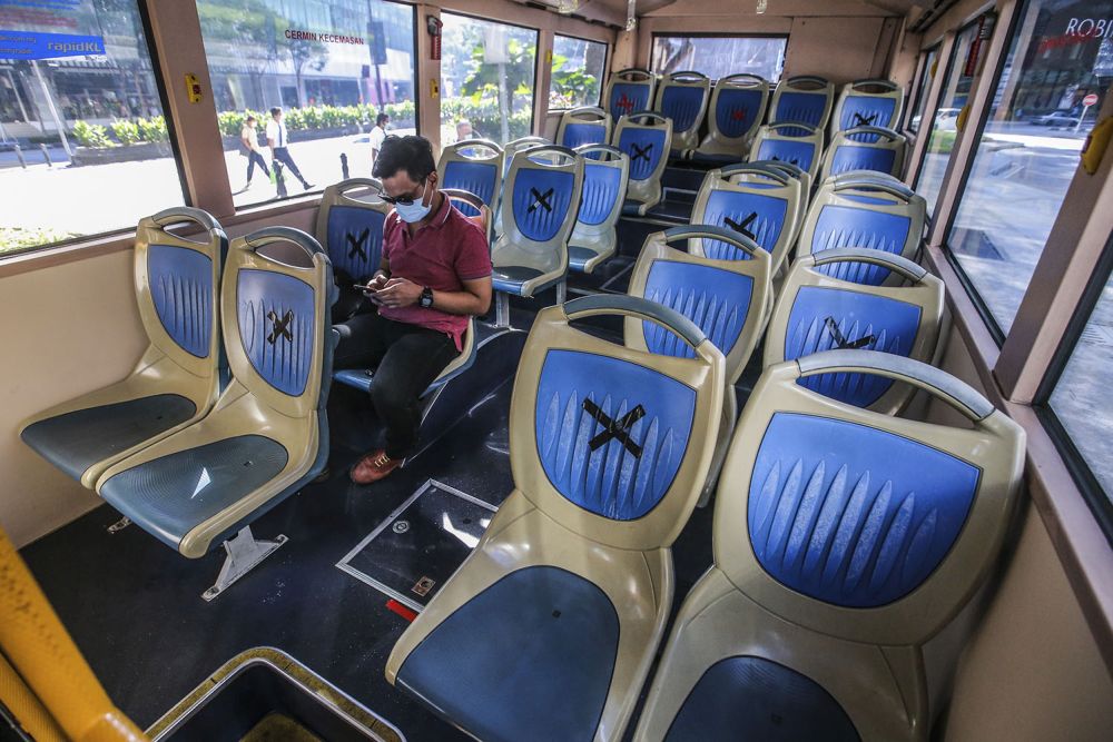 A passenger is pictured aboard a RapidKL bus in Kuala Lumpur on the first day of the conditional movement control order May 4, 2020. u00e2u20acu201d Picture by Hari Anggara