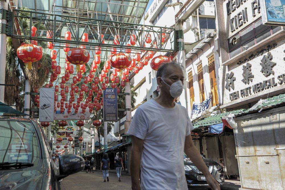 People walk along Petaling Street on the first day of the conditional movement control order in Kuala Lumpur, May 4, 2020. u00e2u20acu201d Picture by Shafwan Zaidon