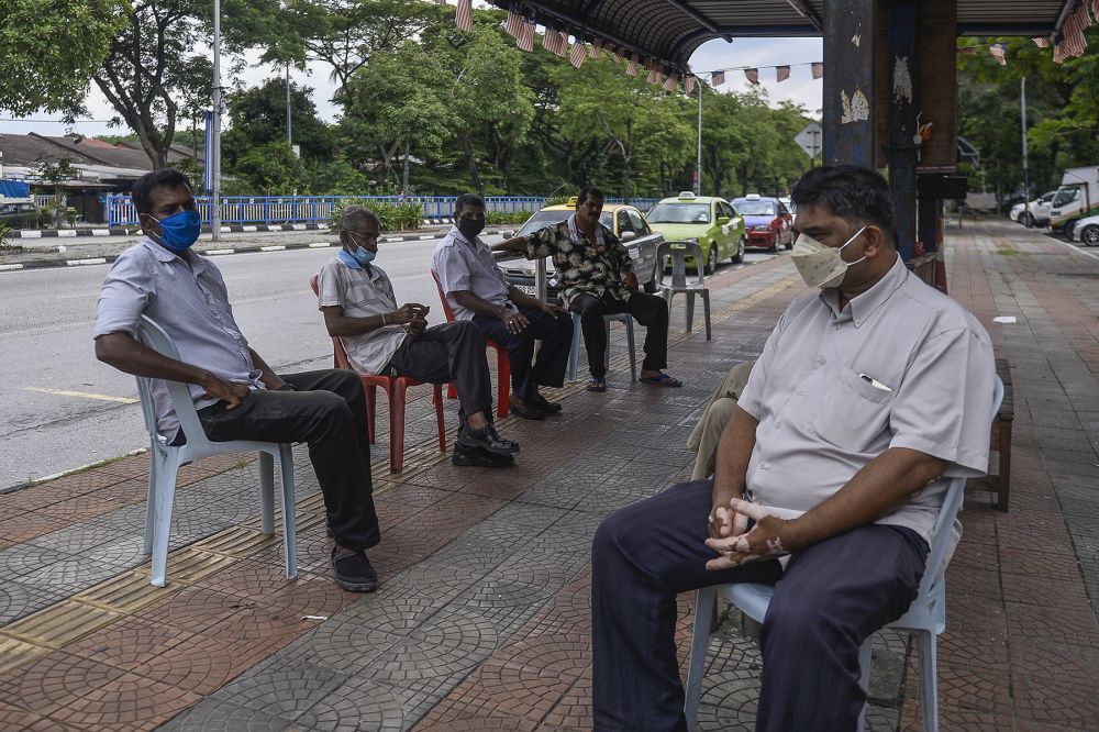 Taxi drivers wait for passengers at a taxi station in Shah Alam during the conditional movement control order May 6, 2020. — Picture by Miera Zulyana