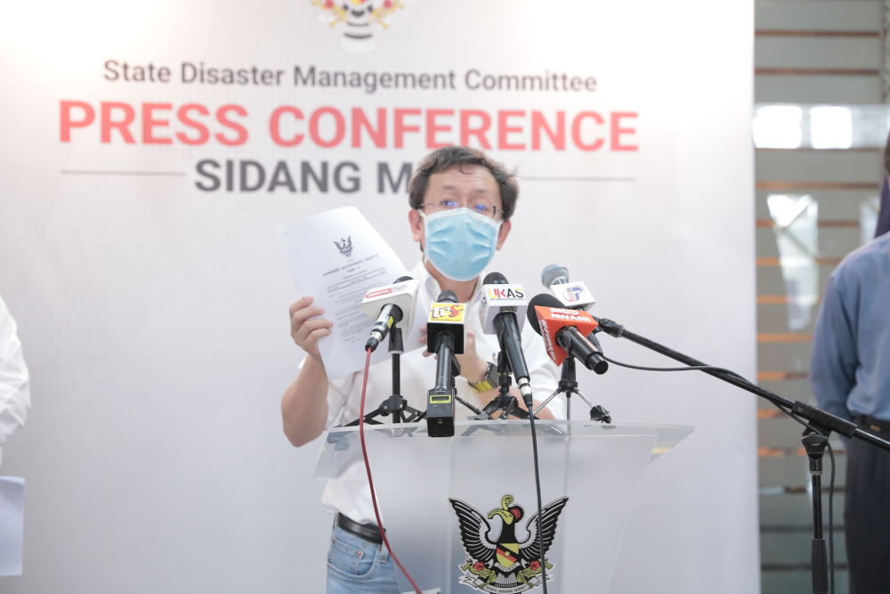 State Local Government and Housing Minister Datuk Seri Dr Sim Kui Hian holds a copy of the gazette notification at a media briefing in Kuching May 14, 2020. u00e2u20acu201d Picture courtesy of Sarawak Public Communications Unit (Ukas)