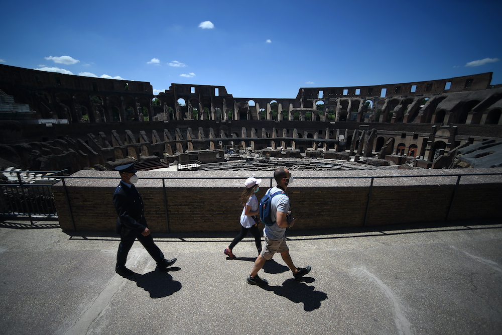 Visitors followed by a member of security staff, walk across the Colosseum monument in Rome, while the country eases its lockdown aimed at curbing the spread of the COVID-19 infection, caused by the novel coronavirus June 1, 2020. u00e2u20acu201d AFP pic