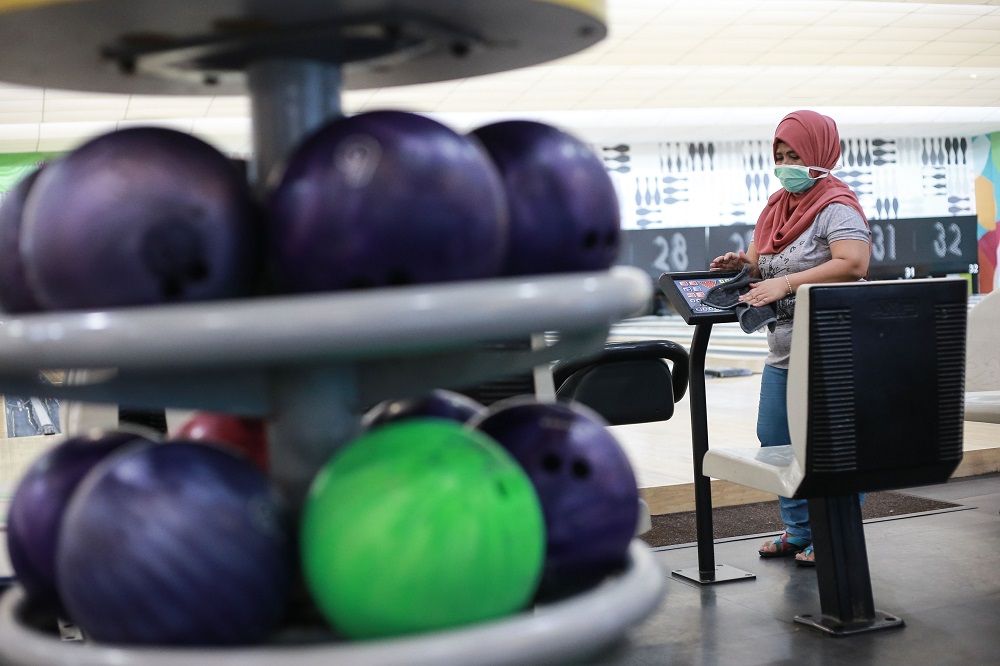 An employee disinfects equipment at Wangsa Bowl, a bowling centre located at Wangsa Walk Mall, in Kuala Lumpur June 9, 2020. u00e2u20acu201d Picture by Ahmad Zamzahuri