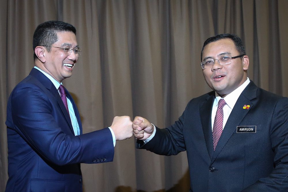 Senior Minister Datuk Seri Mohamed Azmin Ali bumps fists with Selangor Mentri Besar Datuk Seri Amirudin Shari during the Selangor state action council meeting in Shah Alam June 29, 2020. u00e2u20acu201d Picture by Yusof Mat Isa